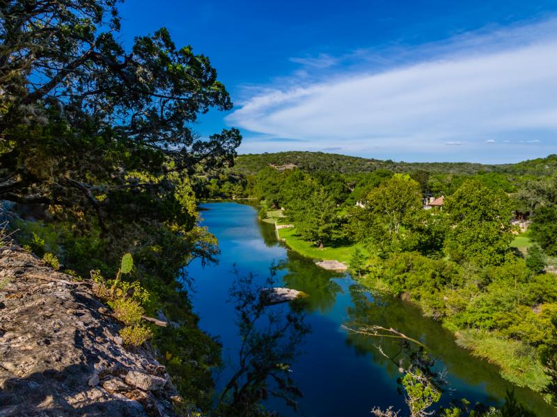 view of cliff and creek land for sale in texas 