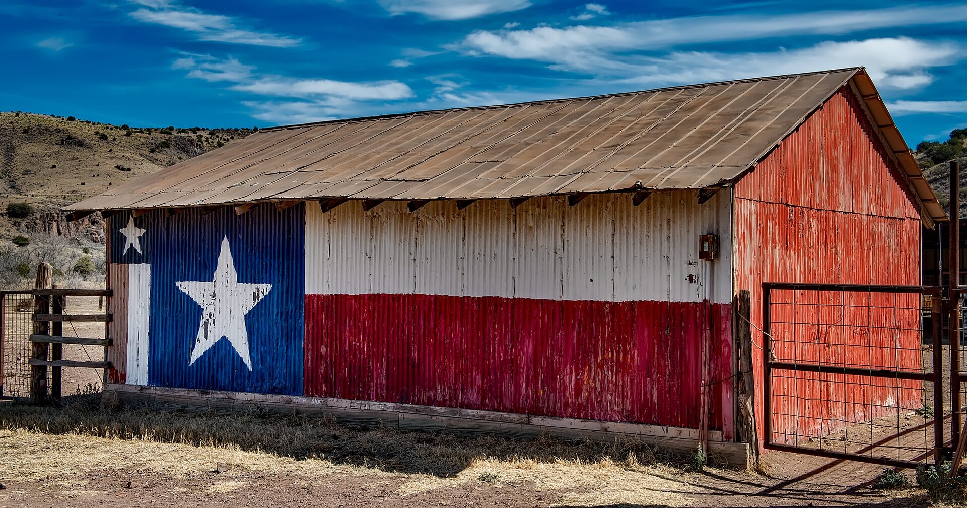 Texas flag on the side of an old barn.